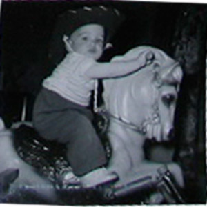 child on toy horse