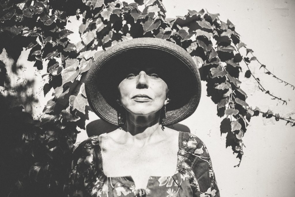 woman standing under leaves