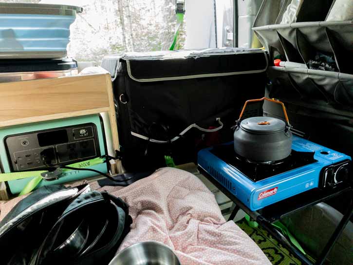 Heating water on camp stove inside a van