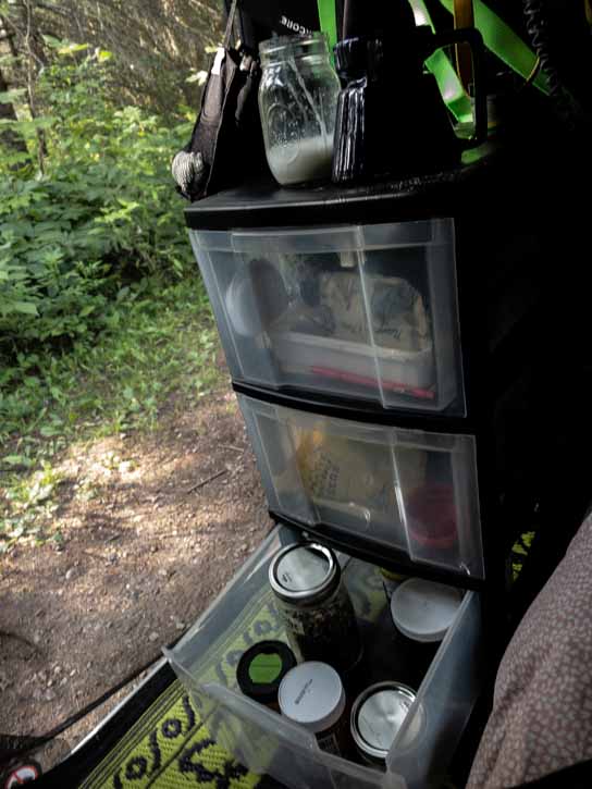 Drawers of food supplies inside a van.