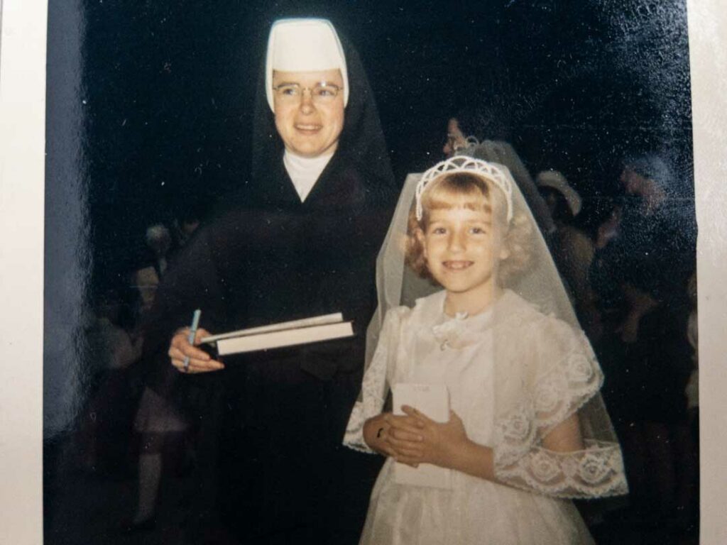 My first communion, posed with a nun