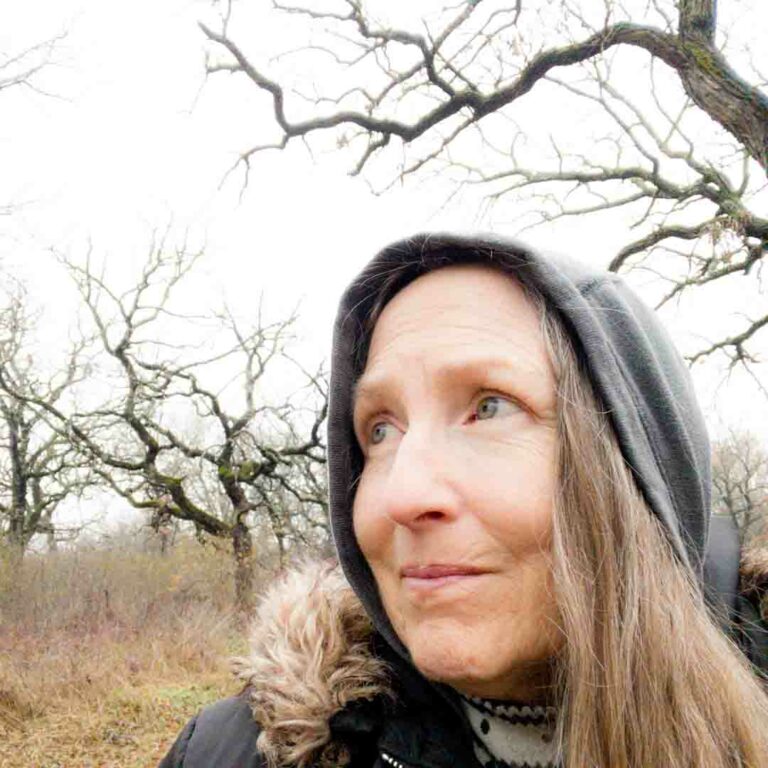 Woman standing under oak trees